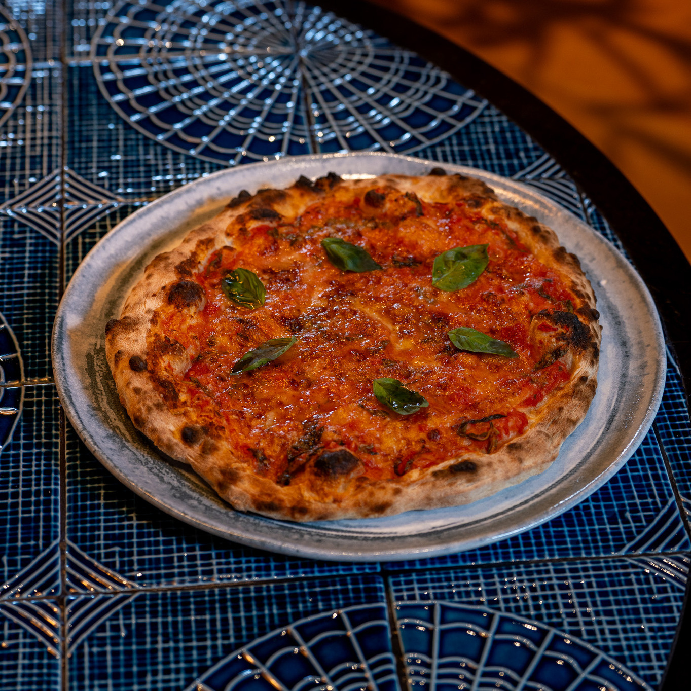 A perfect harmony of tomatoes, mozzarella, fresh basil, olive oil, and a crisp dough.